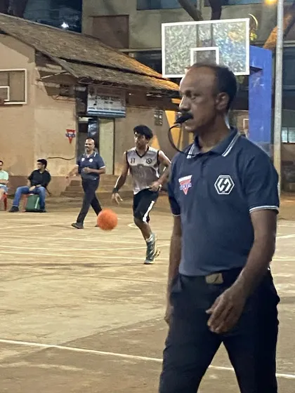 A referee keeping a close watch on the play during a tense eliminator match.