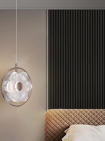 Another view of the flower pendant in a bedroom setting, showing how it complements a modern, textured wall.