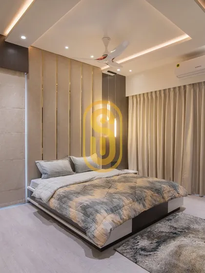 A wider view of the bedroom with the upholstered feature wall, showing the custom bed and matching area rug. The design includes both sheer and blackout curtains for complete light control.