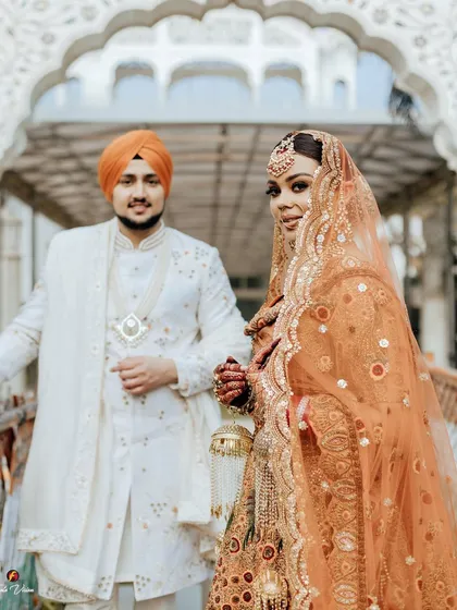 A beautiful shot focusing on the bride, with the groom slightly behind her, capturing her confident and radiant look.