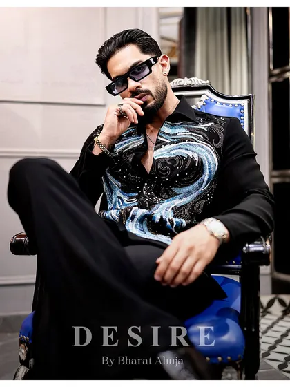 Command attention without saying a word. This seated pose in the abstract wave shirt is all about luxe attitude and unapologetic confidence.