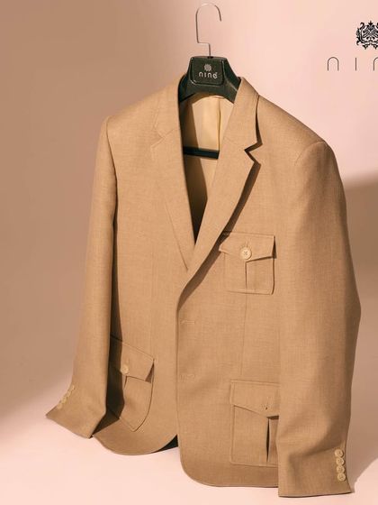 This rich beige jacket is another example of our lightweight construction. It features functional pocket details and is tailored from breathable fabric for all-day comfort.