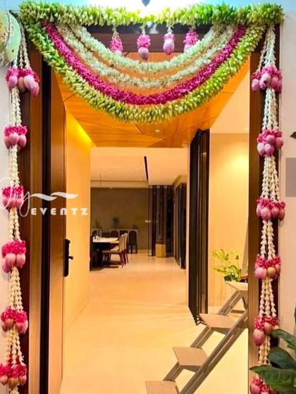 We create stunning main door decorations for housewarming ceremonies. This elegant design features garlands of fresh jasmine and pink lotus buds, creating a beautiful and auspicious welcome for your guests.