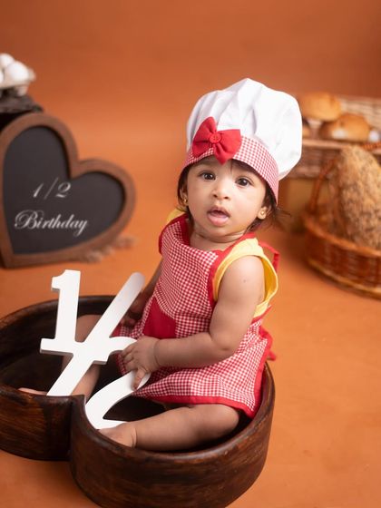Celebrating six months with a fun baker theme! The props and costume come together to create a memorable half-birthday portrait that is full of character.