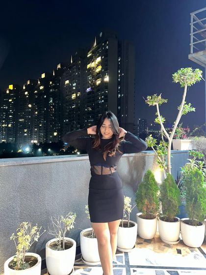 A more candid, hair-fixing moment in the black dress. This adds a natural and unposed feel to the photo.