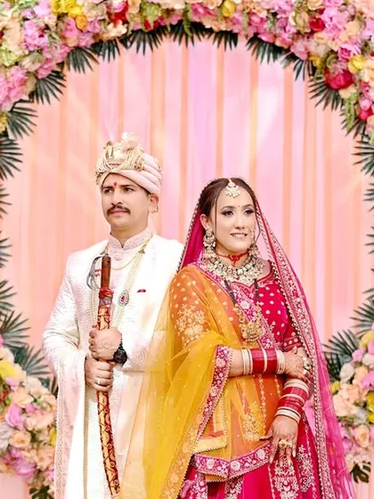 The classic stage photograph, elevated. I ensure the lighting and composition are perfect to create a beautiful portrait of the couple against their floral wedding decor.