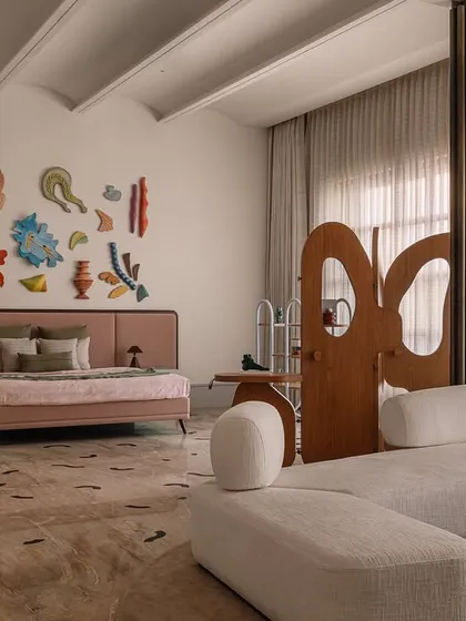 This junior master bedroom is a curated gallery of our custom pieces. The space features our 'Hide and Seek' screen, the 'Line' shelf, and the 'Cane Crush' chaise lounge, all working together to create a layered and texturally rich environment.