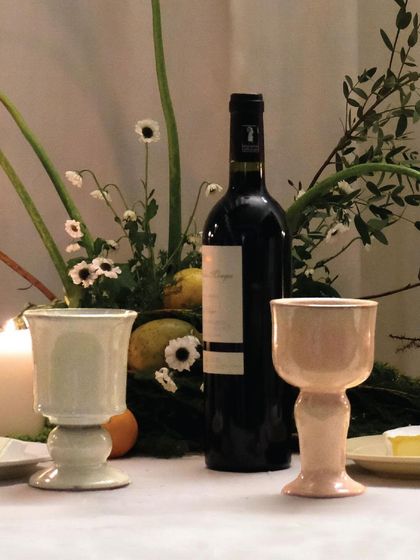 A pair of goblets on a beautifully set table, ready for a celebration. These pieces are designed to bring warmth and elegance to any gathering.