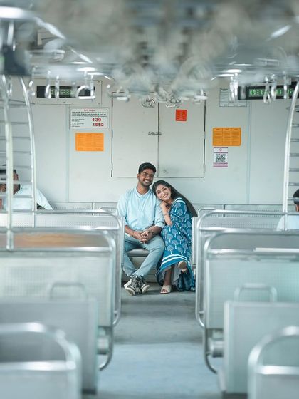 A wider shot that captures the atmosphere of the empty train car, creating a private world for the couple. The leading lines of the seats and handles draw your eye directly to them, making for a powerful composition.