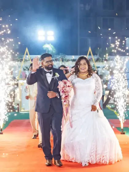 Making a grand entrance as husband and wife! The sparklers light up the path for the happy couple, creating a spectacular and memorable start to their wedding reception.