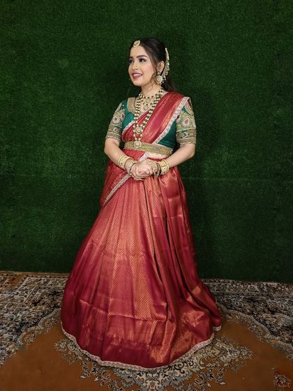 This is my red and green half-saree, another popular color combination for traditional functions. The rich red silk skirt is paired with a heavily embroidered green blouse.