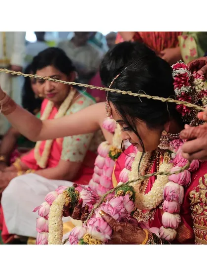 A candid shot during the wedding rituals. The makeup is designed to be long wearing and withstand the duration of the traditional ceremonies.