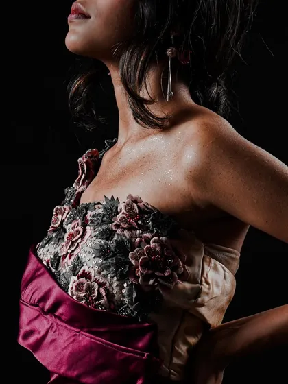 A detailed shot focusing on the intricate floral embroidery on the bodice of a custom gown. For lookbooks, I make sure to capture these close-ups that showcase the unique quality and hard work put into each piece.
