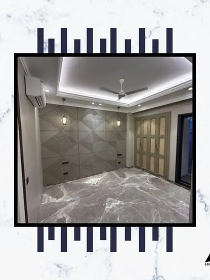 This bedroom features a unique, geometrically patterned feature wall that also serves as a headboard and storage unit. The grey marble flooring adds another layer of texture and luxury.