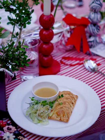A dish from our annual Christmas brunch at CAARA at Ogaan. The festive table setting, complete with red and white stripes, sets the mood for a joyful celebration.