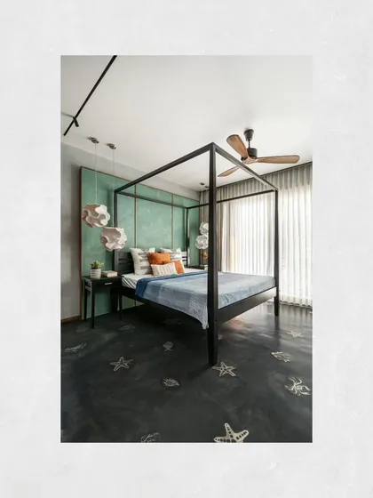 A home should reflect the passions of its owners. This bedroom in the Kamala Residence was inspired by the client's love for deep-sea diving, featuring marine life patterns laser-cut into the oxide flooring and a sea-green patina wall, making the space deeply personal.