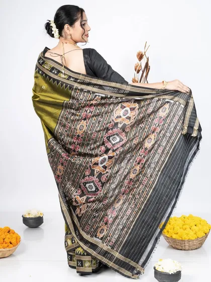 The back view is just as important as the front. Here, the pallu is draped to elegantly display its detailed border and artwork. This style ensures the saree looks complete and graceful from behind, perfect for event photography.