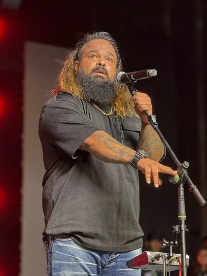 A powerful shot of our frontman on stage, embodying the passion and energy he brings to every performance.