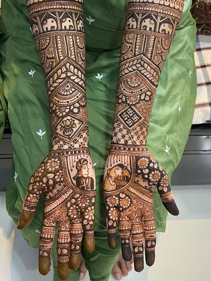A close-up of the palms, highlighting the detailed bride and groom portraits. The use of negative space makes the figures stand out beautifully.