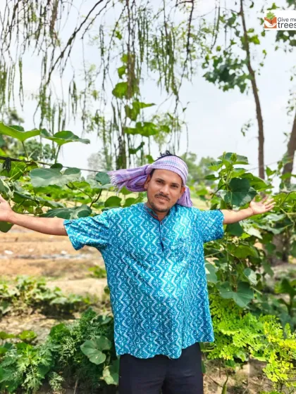 A member of our team stands proudly amidst the thriving vegetable gardens at our Uldeypur site. Our projects often include agroforestry, providing both ecological benefits and sustenance for the local community.