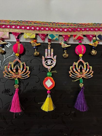This 'Shubh Toran' with its lotus and hamsa symbols has found a new home. The combination of tassels, beads, and little birds brought so much positive energy to this piece.
