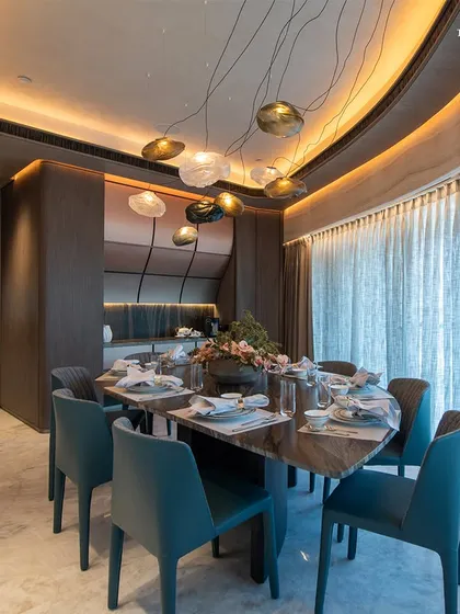 A closer view of the dining area at Lodha World View, where the design reflects the family’s love for fine living. Illuminated by soft, ambient lighting from the sculptural pendants, the space fosters an inviting atmosphere for intimate dinners and lively gatherings.
