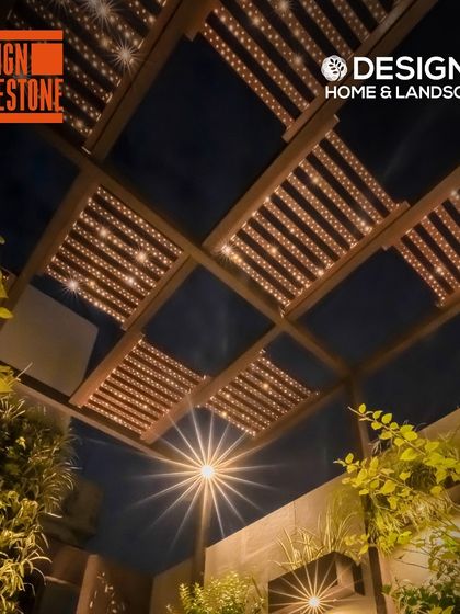 A promotional image for the Design Milestone event, featuring one of our projects with a beautifully lit pergola.