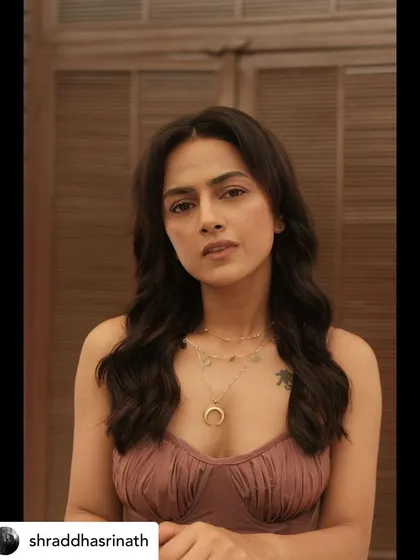 Another portrait of Shraddha, showcasing the elegant neckline of the mauve top and the warm, natural makeup.