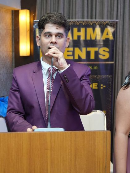 Speaking from the podium at a Brahma Events corporate function. A clear and confident voice is essential for commanding the room.