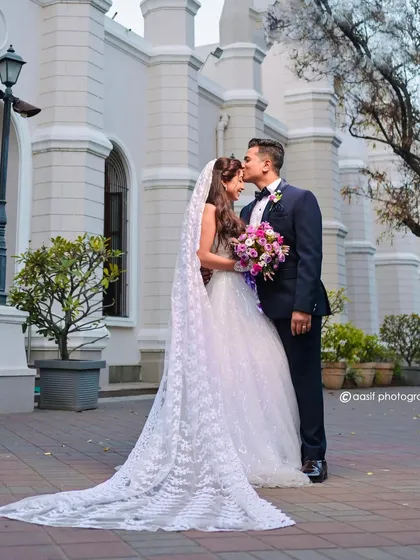 For that classic, storybook wedding feel. This pristine white bridal gown with its delicate veil and long train is perfect for a church ceremony or a timeless pre-wedding photoshoot.