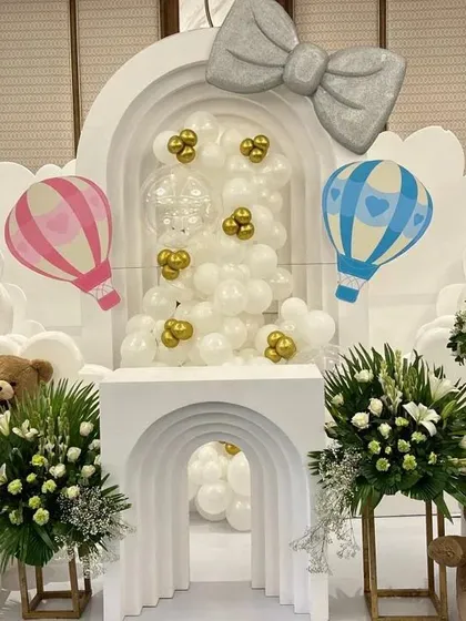 A full view of our 'Up and Away' hot-air balloon themed baby shower. The symmetrical design with two floral arrangements and teddy bears creates a balanced and grand photo opportunity.
