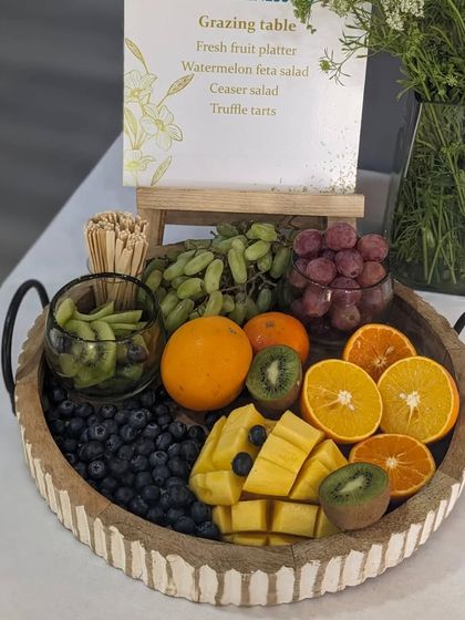 A close-up of the fresh fruit platter for The Wellness Co., showcasing a colorful mix of mango, kiwi, blueberries, and oranges. A perfect, healthy indulgence.