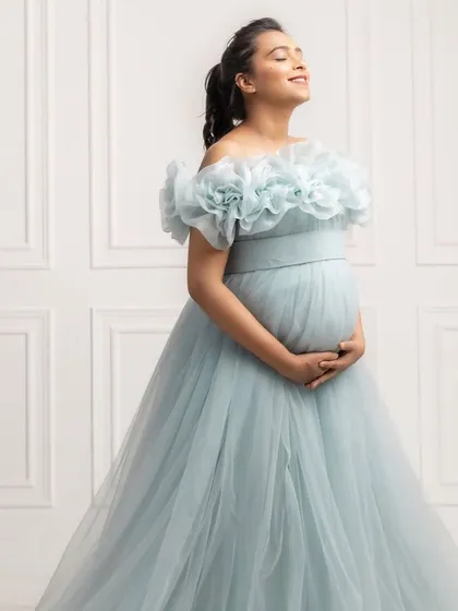 Soaking in the moment. This close-up shows the beautiful texture of the ice blue tulle and the intricate floral detail on the off-the-shoulder neckline.
