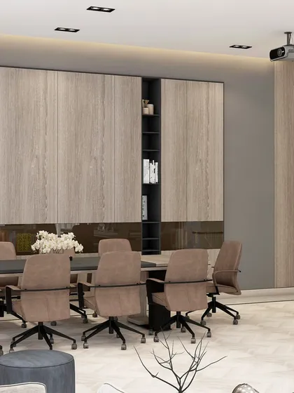 This view highlights the storage and presentation solutions within a modern boardroom. We integrated full-height wood-paneled cabinetry and vertical accent lighting to create a space that is both highly functional and architecturally impressive.