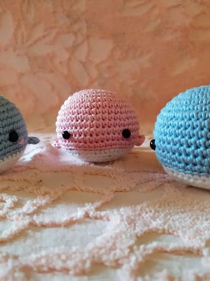 A lineup of the three whale buddies in different shades of blue and pink. These crochet plushies make wonderful handmade gifts.