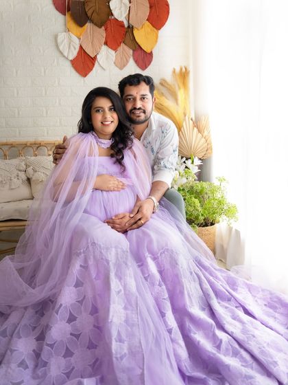 A classic couple's portrait, both looking at the camera with warm smiles, capturing their happiness together.