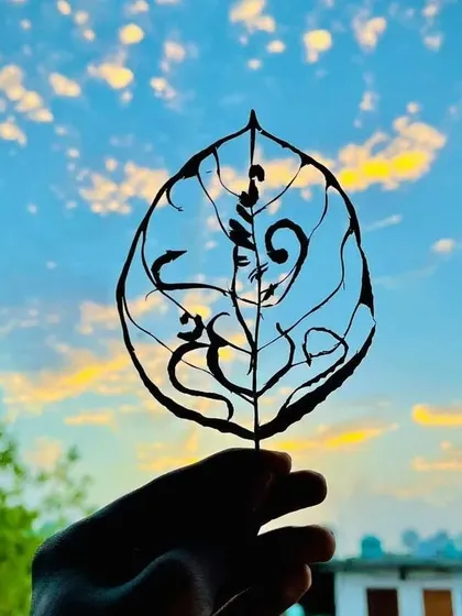 The sacred 'Om' symbol carved into a Peepal leaf. I love creating spiritual art that feels connected to nature, and the simple elegance of this design is very meaningful to me.