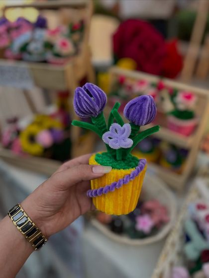 A whimsical potted tulip arrangement made from pipe cleaners and yarn, showcased at one of our market stalls.