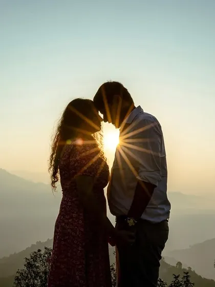 Sometimes, the most romantic shots are the simplest. A classic sunset silhouette against the fading light over the hills is a timeless way to capture the intimacy and connection between you two.