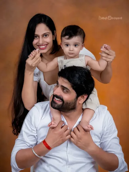 The best things come in small packages! A fun shoulder ride for the baby makes for a delightful and heartwarming family photo.