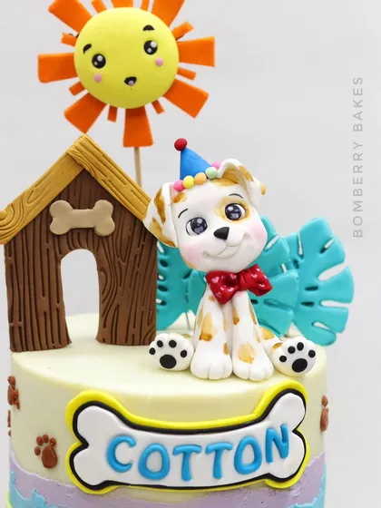 Another angle of the adorable dog figurine, "Cotton," complete with a party hat and bow tie.