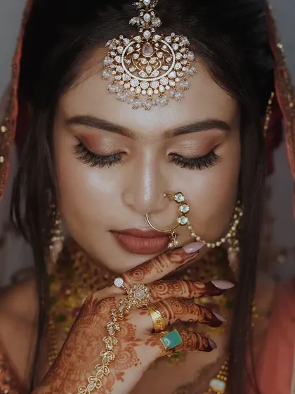 A stunning close-up of a bride, focusing on the intricate details of her makeup, jewelry, and the emotion in her eyes. Bridal portraits are a key part of my service.