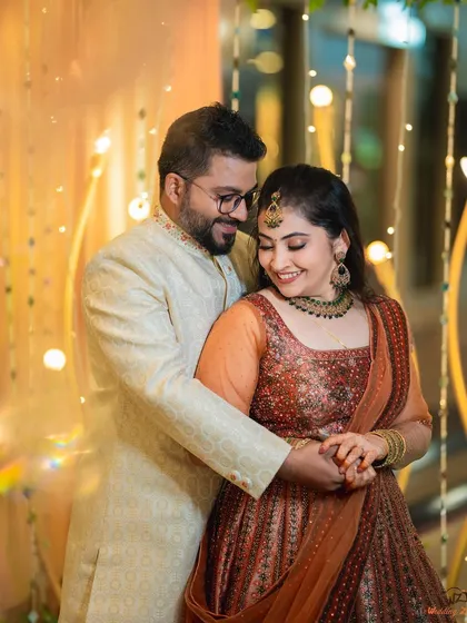 A warm and intimate portrait of Rohan and Pooja, surrounded by soft, glowing lights. This kind of lighting is perfect for creating a romantic mood.