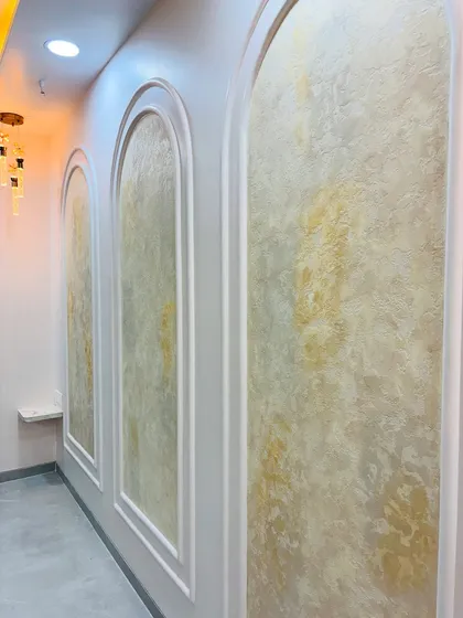 Final touches being applied to the POP moulding around the textured wall panels.