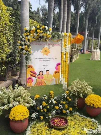 A personalized welcome sign for a Haldi event, decorated with marigold and white flower arrangements. These small details help in creating a customized experience for the couple.