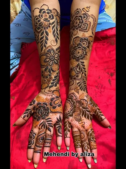 A full-arm floral mehendi design with bold flowers and leaves.