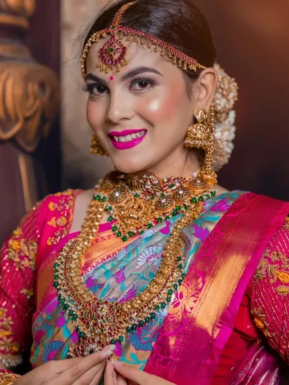 A happy and bright close-up, showing the details of the jewellery and the vibrant lip color.