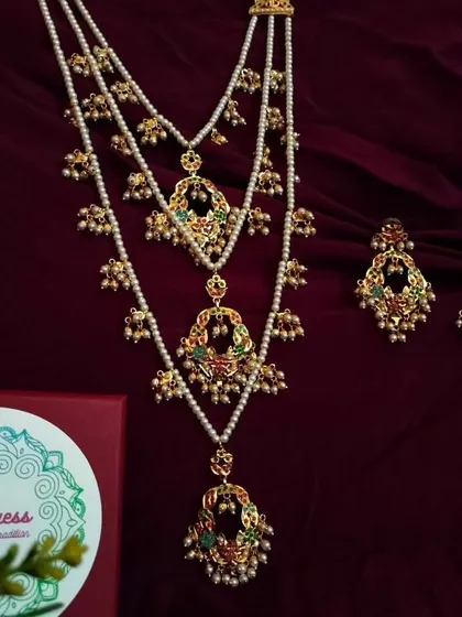 My 'Triveni' necklace set, a pre-layered masterpiece for that complete, regal look. This limited edition piece combines three distinct layers of Jadau and pearl work, creating effortless grandeur.