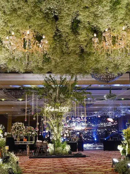 For a 70th birthday, I designed this breathtaking entrance under a canopy of baby's breath and sparkling chandeliers. It was about creating a heavenly, dream-like passage to celebrate a life filled with beautiful moments.