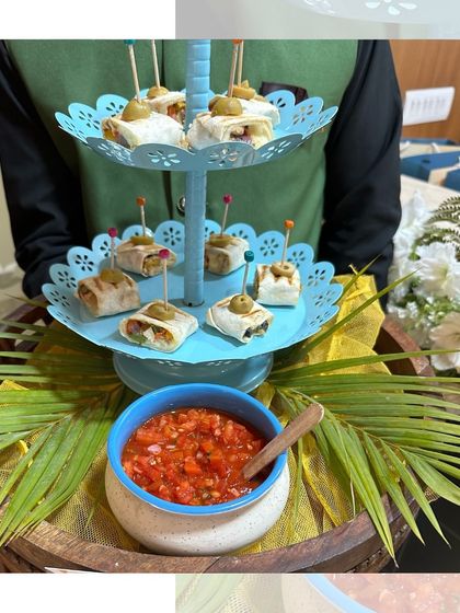 Zesty Fajita Bites served on a tiered stand with a side of fresh salsa. These tortilla roll-ups are a convenient and flavourful party snack.